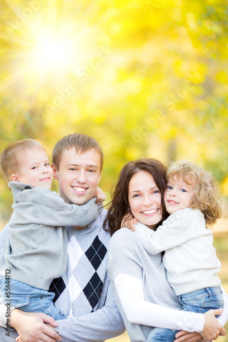 Happy family in autumn park