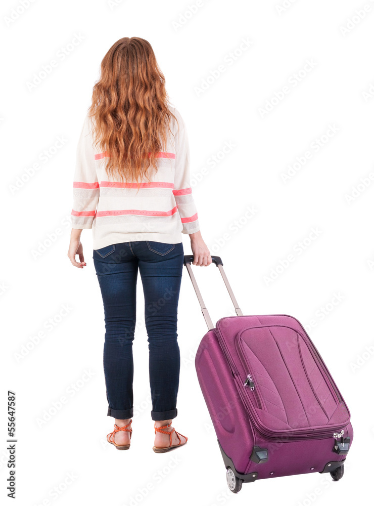 back view of walking woman with suitcase. back view of walking woman with suitcase.