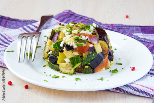 Salad of baked vegetables with feta cheese on plate