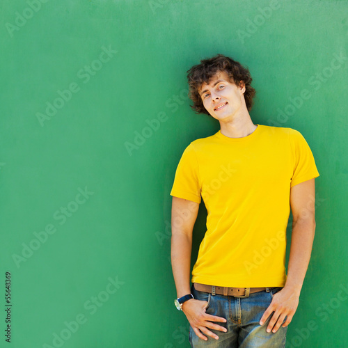 man with curly hair in a yellow T-shirt © stakhov