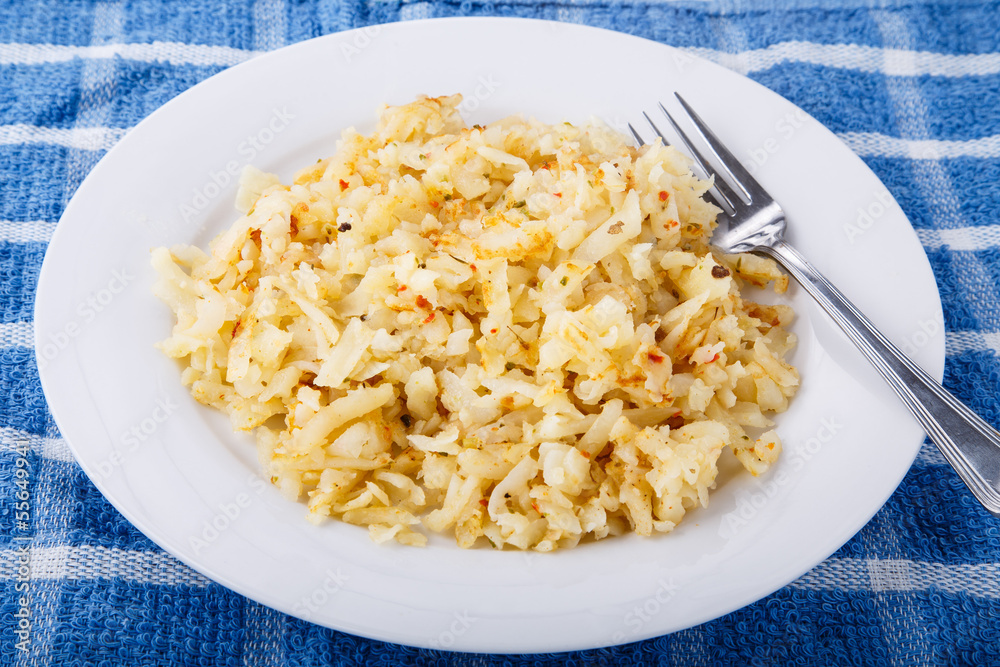 Hash Brown Potatoes on White Plate with Fork Hash Brown Potatoes on White Plate with Fork