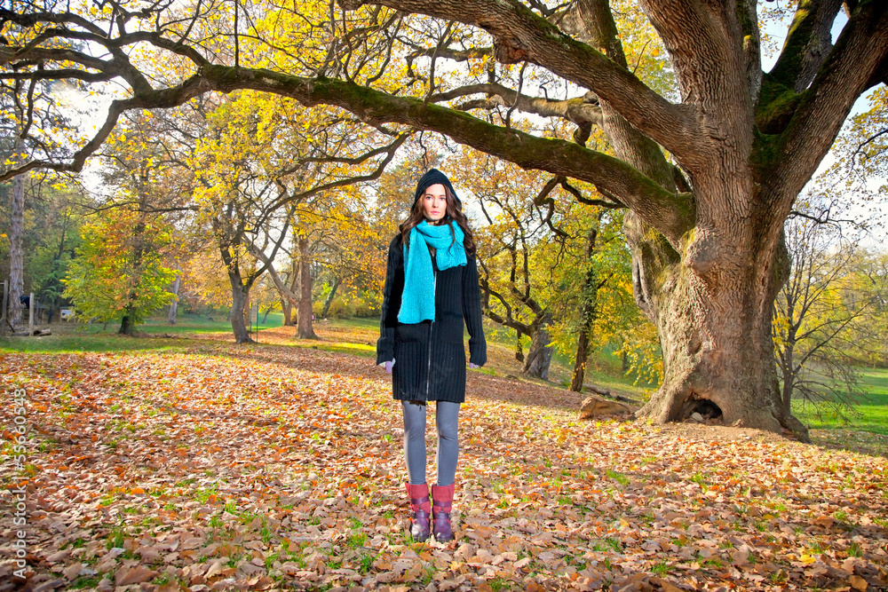 Beautiful girl in front of big tree in park Beautiful girl in front of big tree in park