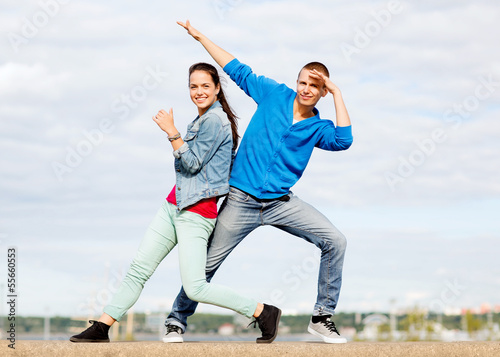 couple of teenagers dancing outside