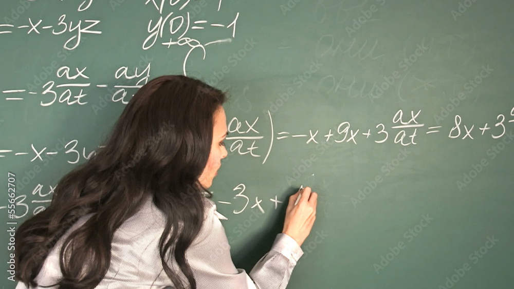 Happy schoolchild writing on blackboard. Happy schoolchild writing on blackboard.