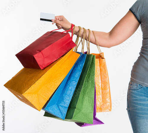 Woman's hand holding shopping bags and credit card