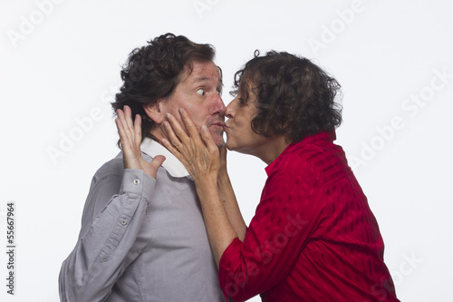 Woman stealing a kiss from man, horizontal