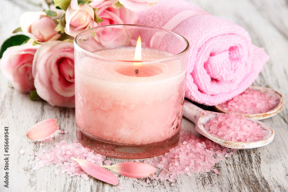 Beautiful spa setting with pink candle and flowers Beautiful spa setting with pink candle and flowers