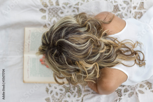 Beautiful girl with book on the floor