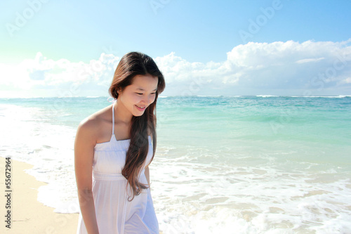 Young happy woman running on the beach