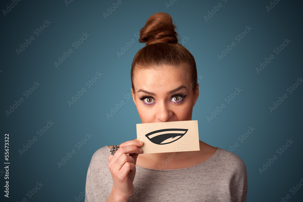 Pretty young girl holding white card with smile drawing Pretty young girl holding white card with smile drawing