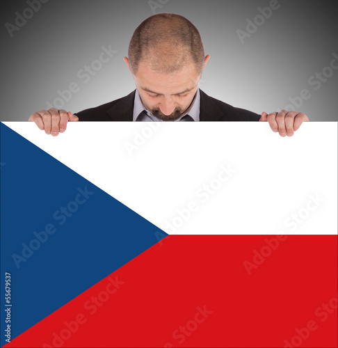 Smiling businessman holding a big card, flag of the Czech Republ photo