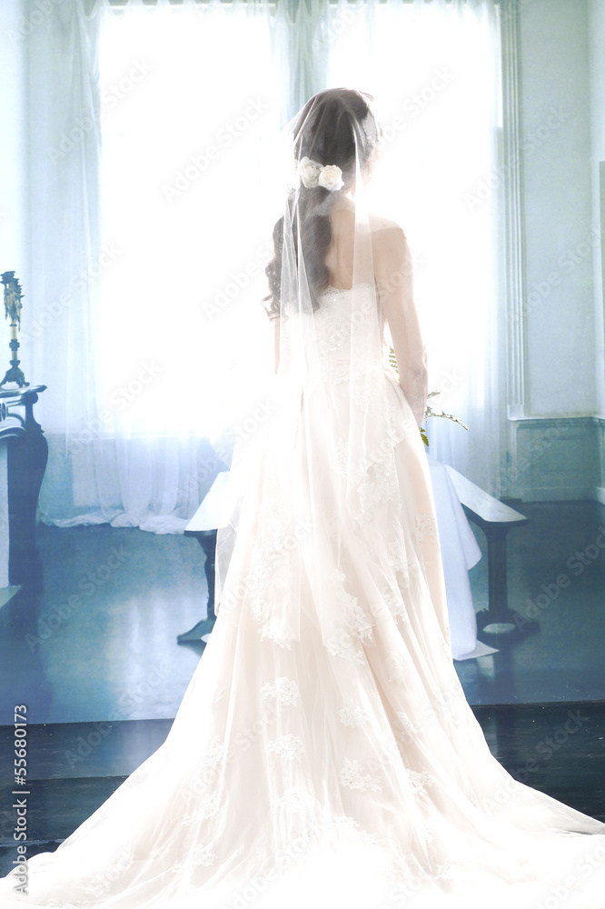 smiling girl in a white wedding dress back posing smiling girl in a white wedding dress back posing