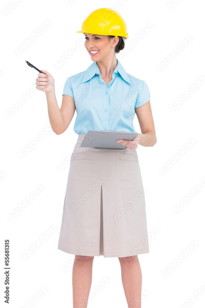 Cheerful attractive architect holding clipboard Cheerful attractive architect holding clipboard