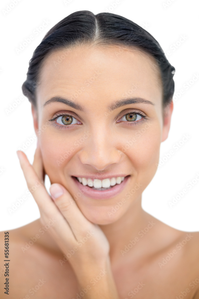 Smiling sensual model posing touching her cheek Smiling sensual model posing touching her cheek