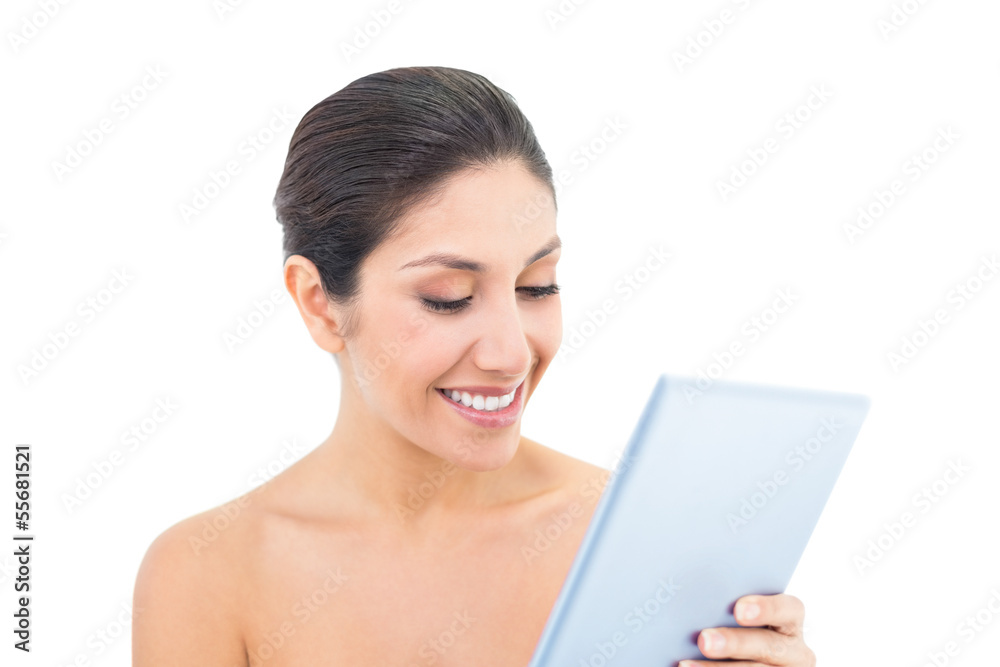 Attractive brunette using a digital tablet Attractive brunette using a digital tablet
