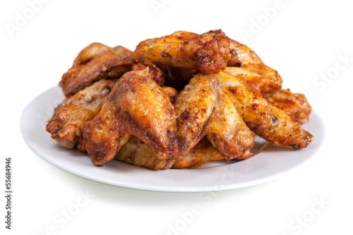 Plate of delicious barbecue chicken wings, on white