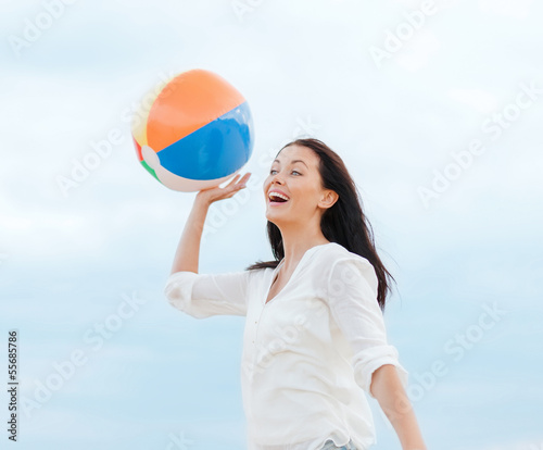 girl with ball on the beach