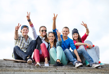 group of teenagers showing finger five