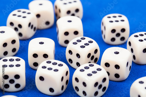 Dice rolling on blue background