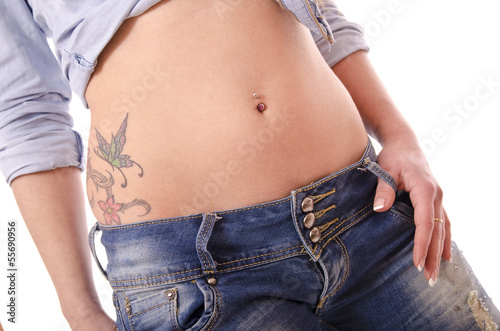 Sexy hip with piercing and tattoo. © FotoAndalucia