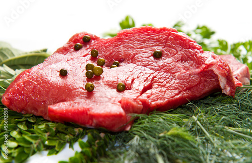 a red meat with sage and rosemary isolated on white background