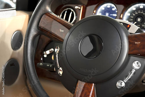 steering wheel of a classic luxury car © monstersparrow