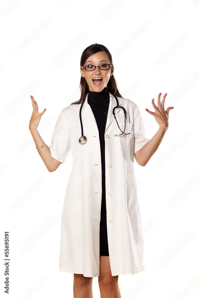 happy and smiling young woman doctor posing on white background
