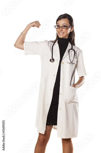 smiling young woman doctor gesture strength with her hand