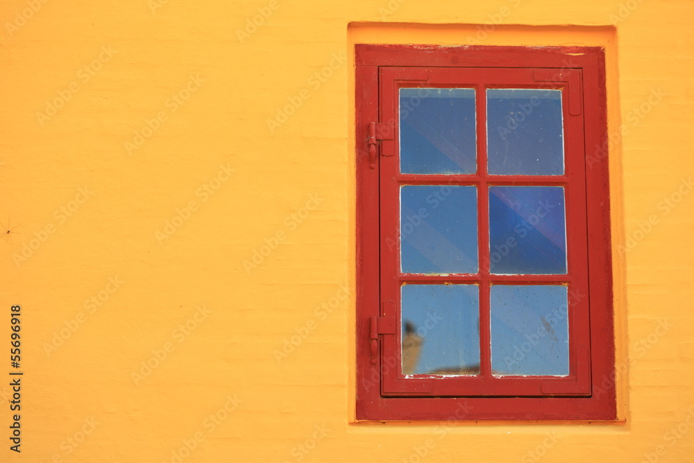 red window on orange wall architecture detail