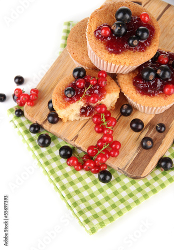 Tasty muffins with berries isolated on white