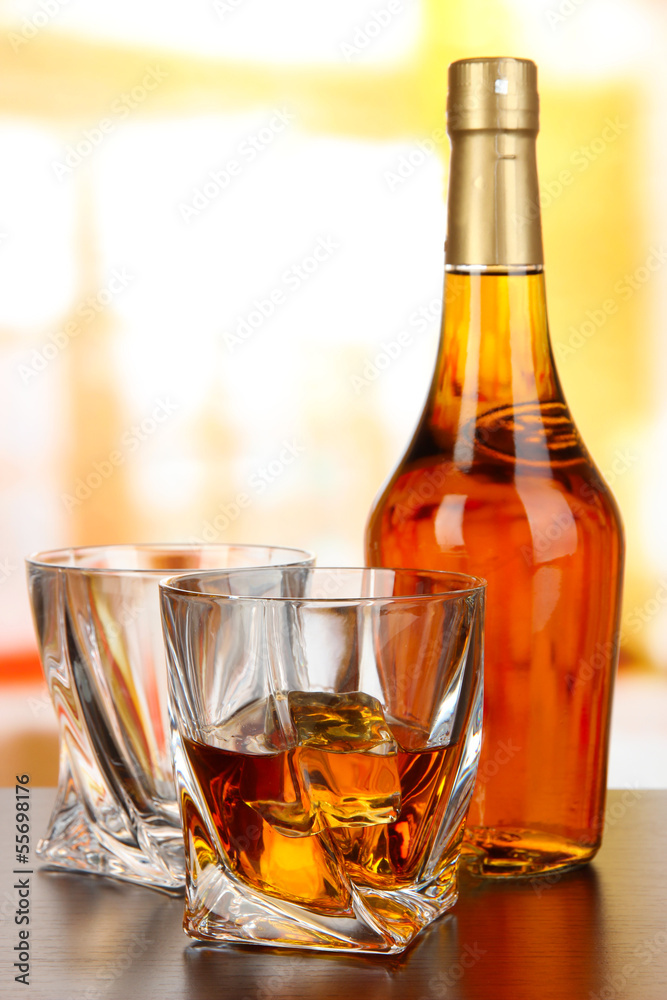 Glass of whiskey with bottle, on dark background Glass of whiskey with bottle, on dark background