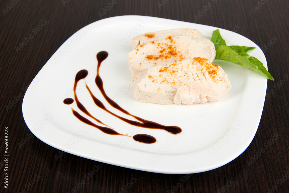 Boiled chicken meat with paprika and sauce, on wooden