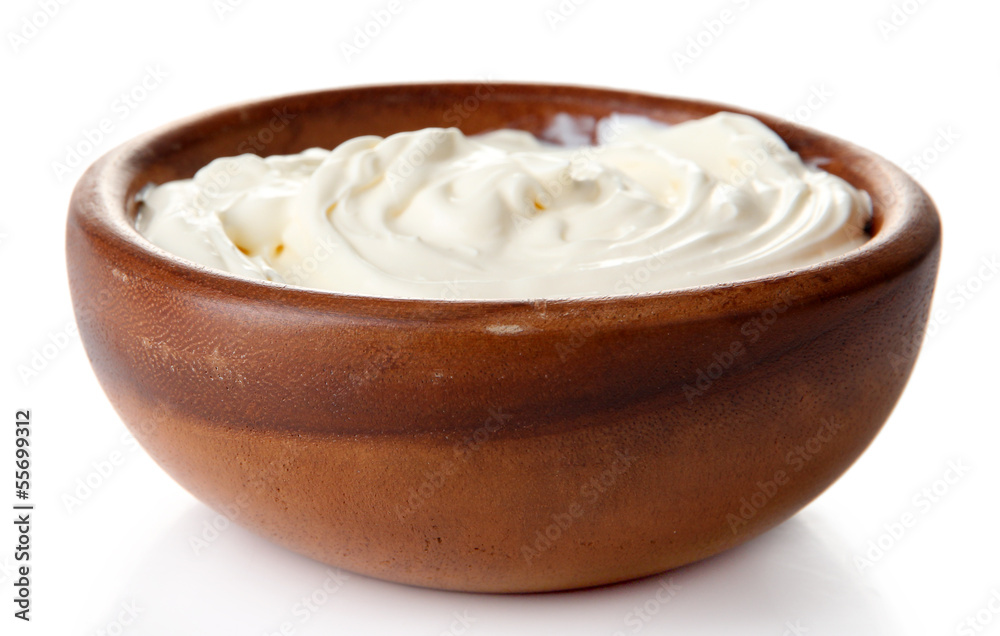 Sour cream in bowl isolated on white Sour cream in bowl isolated on white