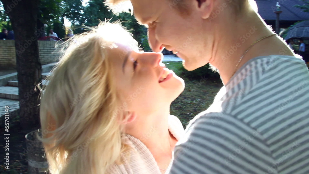 Steadycam shot of romantic dusk kisses in park young couple Steadycam shot of romantic dusk kisses in park young couple