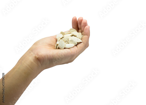 girl hand hold many pumpkin seed isolated