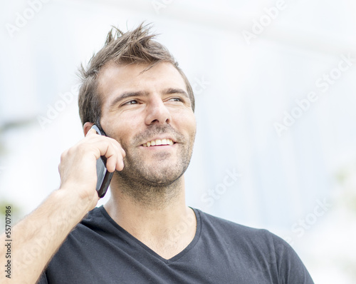 Portrait of smiling man talking on phone.