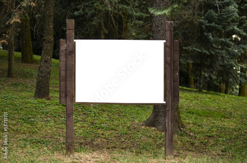 Blank wooden billboard in park