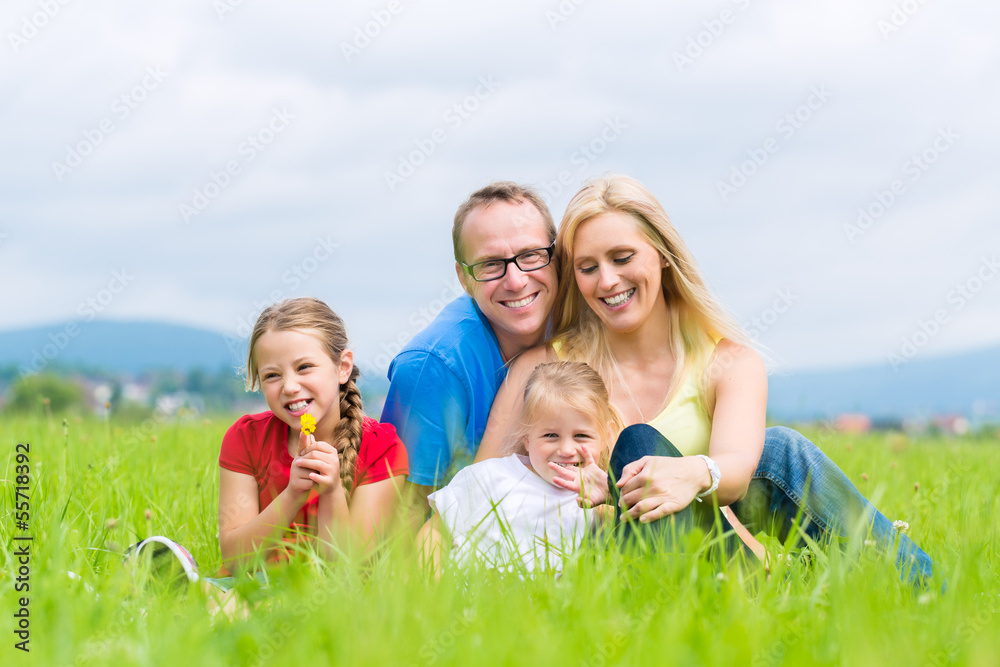 Fototapeta premium Happy Family outdoors sitting on grass