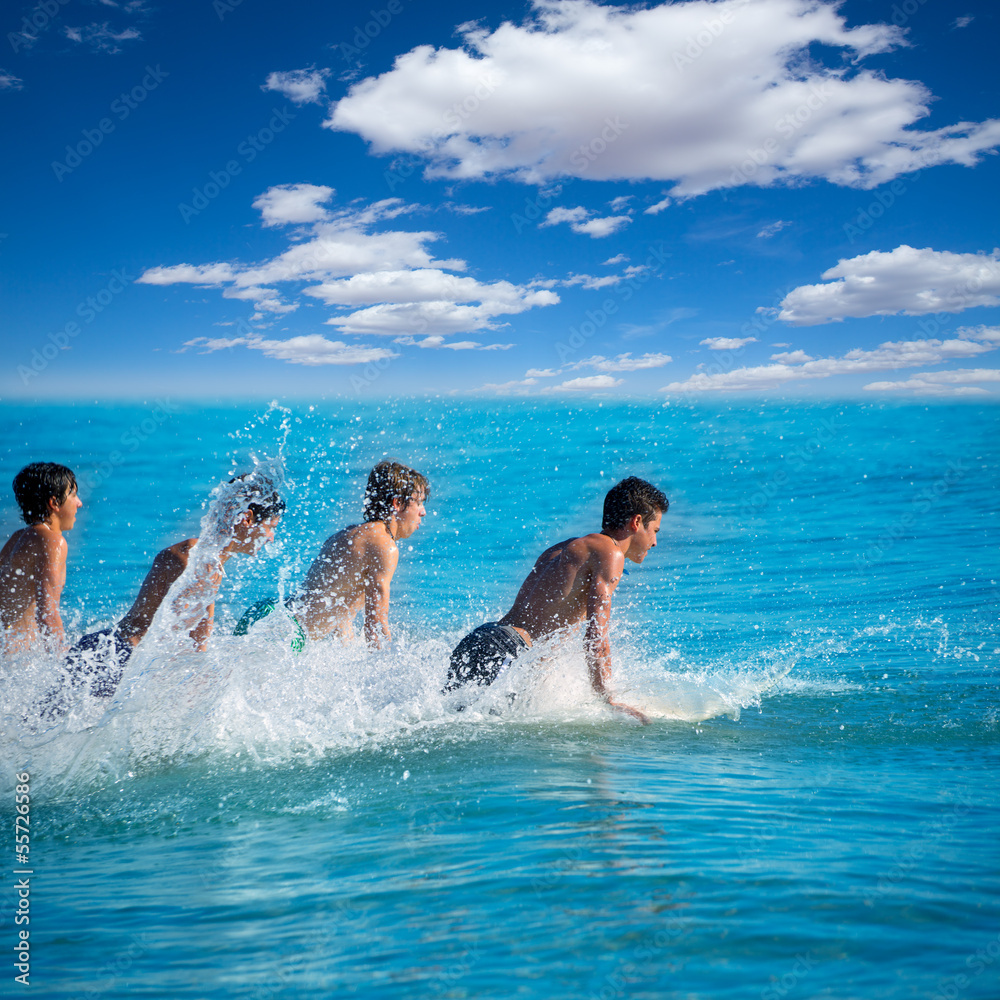 Boys surfers surfing running jumping on surfboards Boys surfers surfing running jumping on surfboards