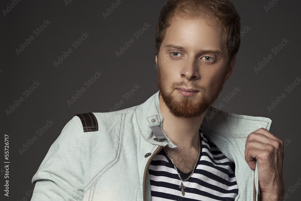 Obraz premium a guy with a beard in a denim jacket