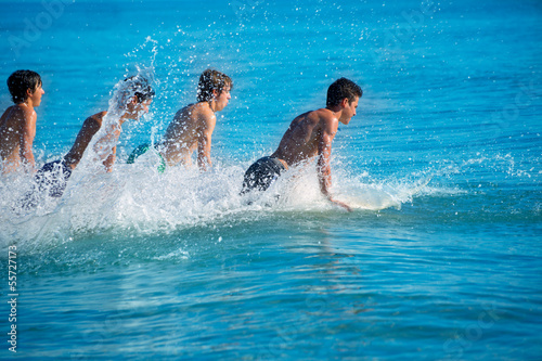 Boys surfers surfing running jumping on surfboards © lunamarina