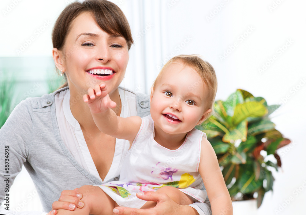 Happy Smiling Mother and Baby kissing and hugging at Home Happy Smiling Mother and Baby kissing and hugging at Home