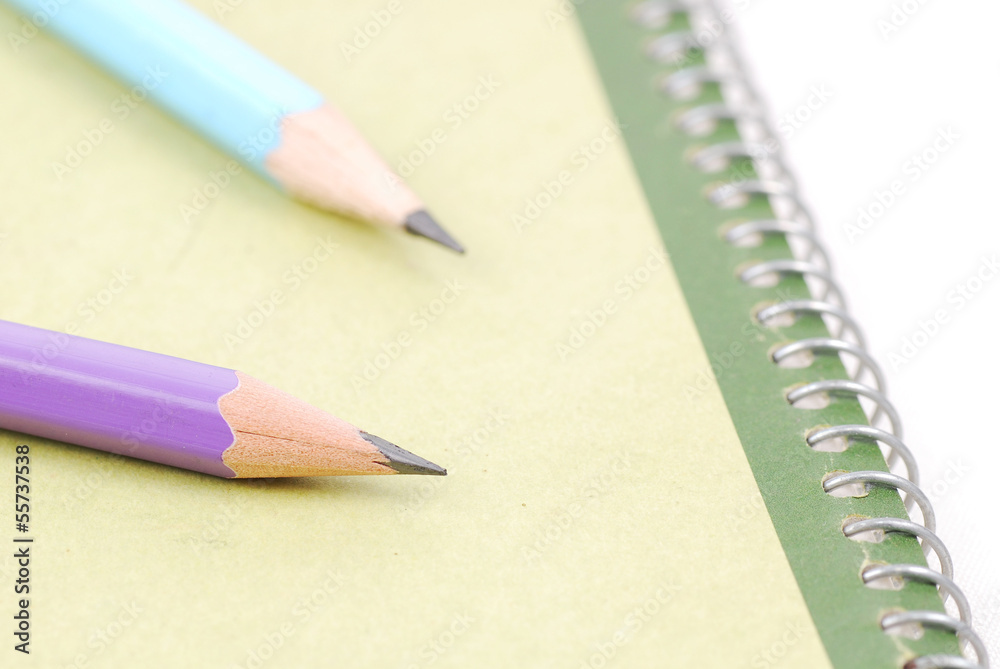 Pencils on green notebooks Pencils on green notebooks