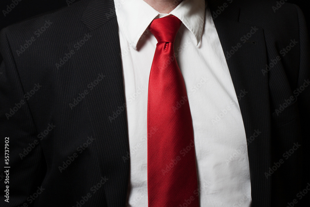 Man in shirt an suit with red tie