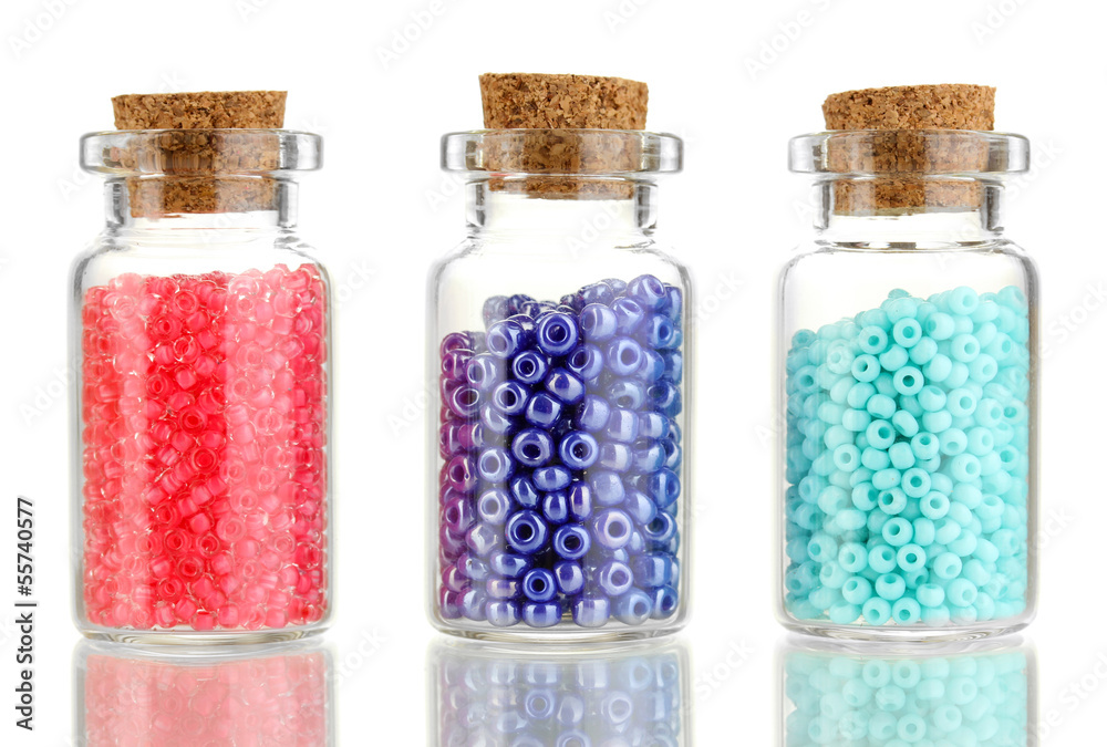 Little bottles full with colorful beads isolated on white Little bottles full with colorful beads isolated on white