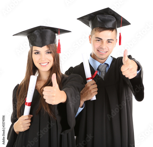 Two happy graduating students isolated on white photo