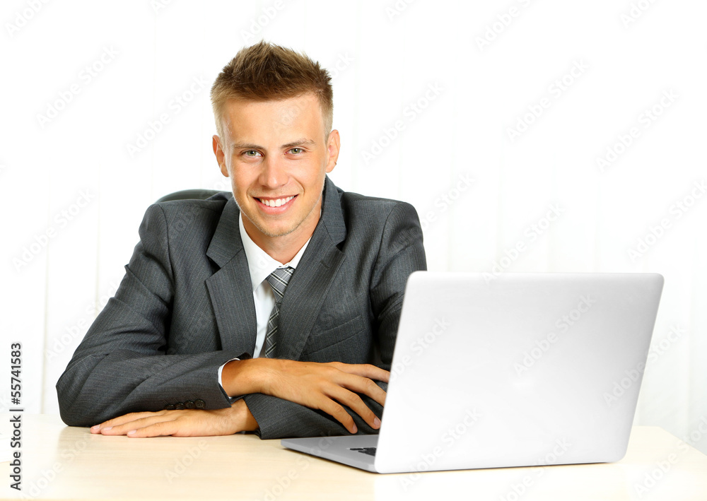 Portrait of young businessman working in office Portrait of young businessman working in office