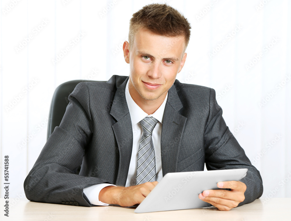 Portrait of young businessman working in office Portrait of young businessman working in office