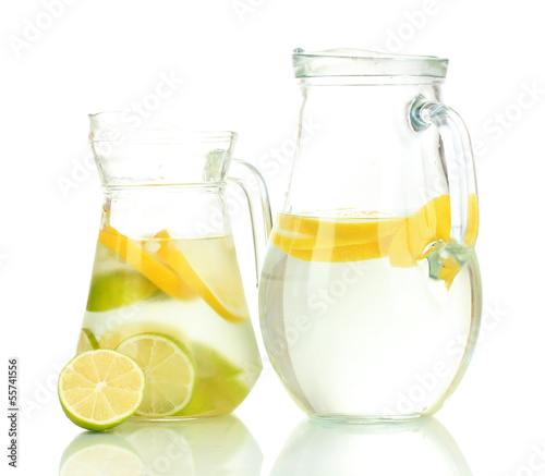 Cold water with lime, lemon and ice in pitchers isolated