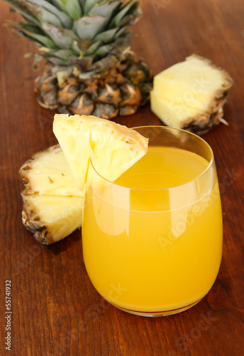 Delicious pineapple juice on table close-up